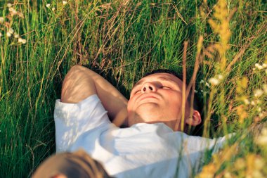 Young adult man in spring grass clipart