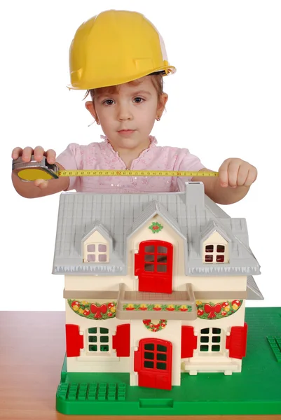 Little girl builder with toy house — Stock Photo, Image