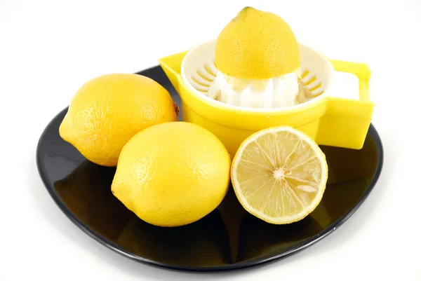 stock image Lemon and strainer on black dish