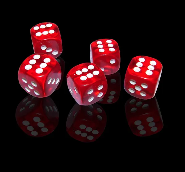 Red dice on black background — Stock Photo, Image