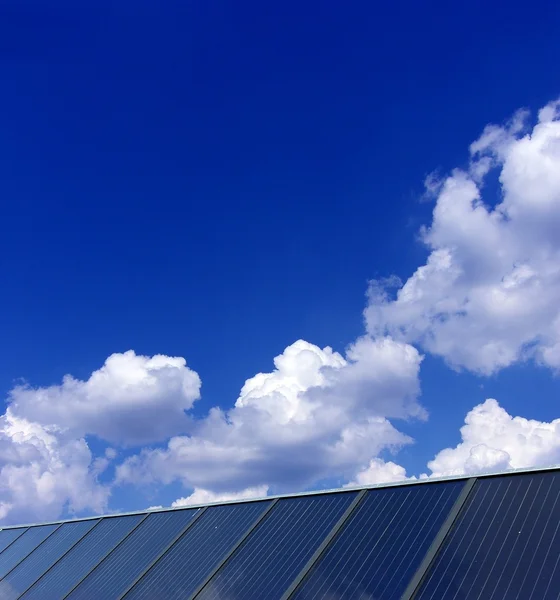 Облачно-голубое небо над солнечной батареей — стоковое фото
