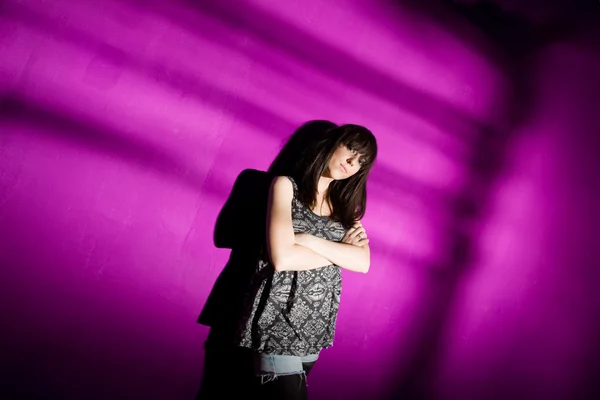 Bezorgd vrouw op roze muur — Stockfoto