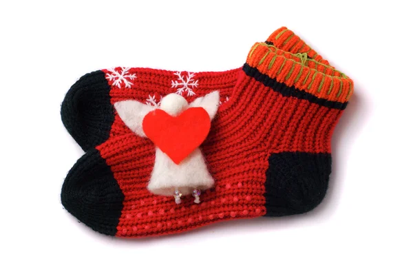 Par de calcetines rojos para niños pequeños con ángel Imagen de stock