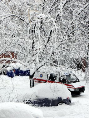 Ambulance rides through snowdrifts clipart