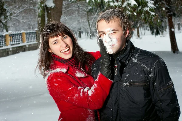 Beautiful couple playing in snow — Stock Photo, Image