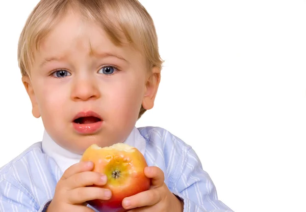 Jeune garçon mangeant des pommes Image En Vente