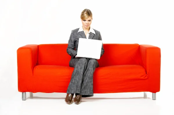 Kvinna på röd soffa — Stockfoto