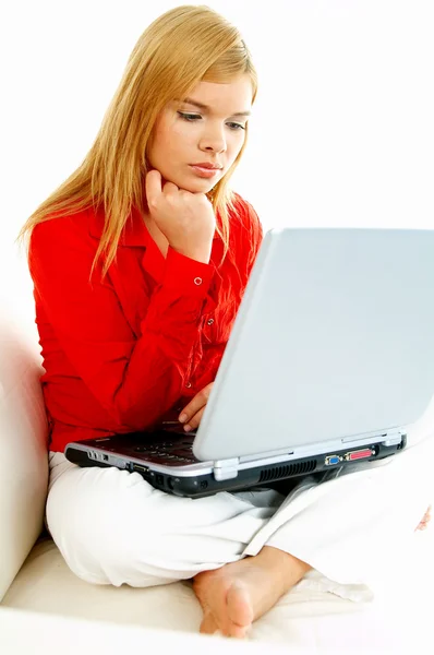 Women with laptop on couch Stock Picture