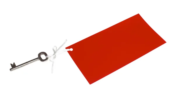 Gammal nyckel med röd etikett — Stockfoto