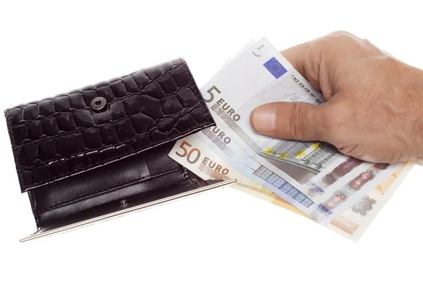 Hand holding a euro into wallet — Stock Photo, Image
