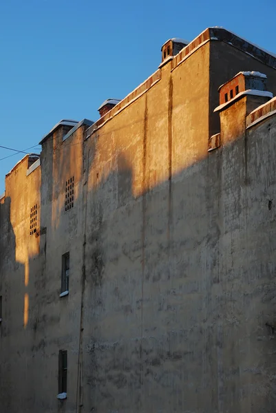 Stock image Old yellow wall on a blue sky