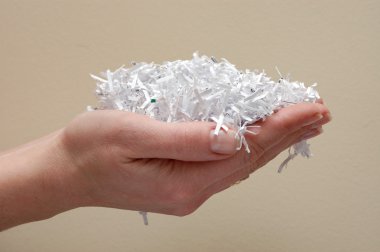 Hand holding shredded paper clipart