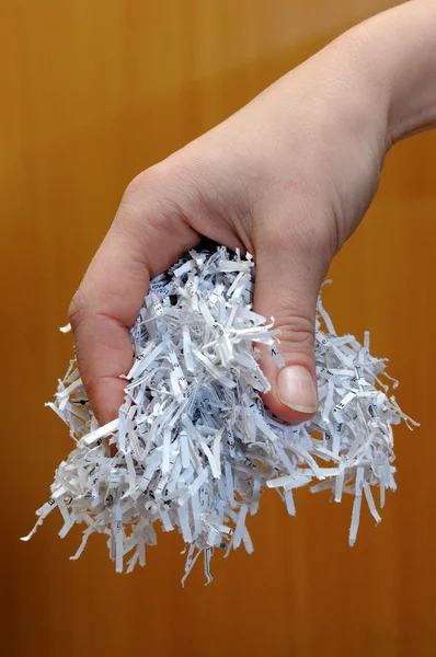 Hand holding shredded paper — Stock Photo, Image