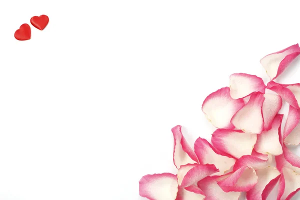 Rosenblätter und zwei Herzen — Stockfoto