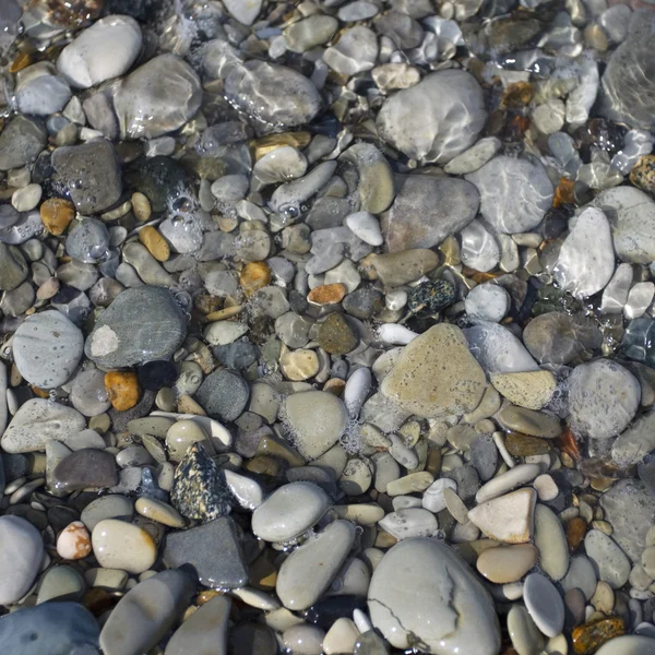 Pebbles and stone in the sea water — Stock Photo, Image