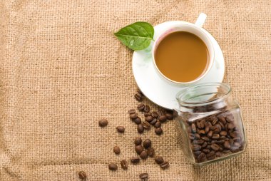 Fresh coffee with beans in glass jar clipart