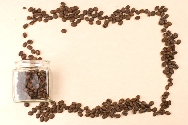 Grãos de café em jarra de vidro como moldura — Fotografia de Stock