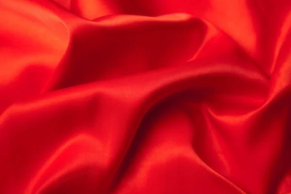 stock image Red rose on a red satin