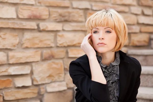 Stock image Beautiful woman near wall