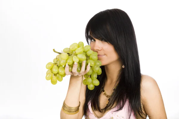 Brunette with green grapes — Stock Photo, Image