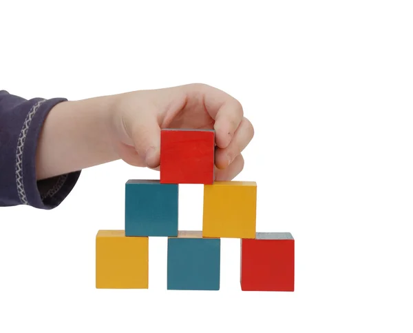 Child hand make a building of blocks — Stock Photo, Image