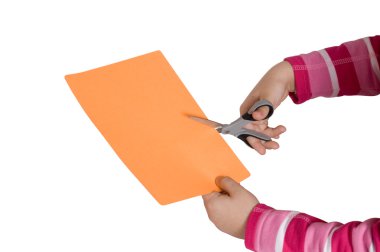 Child hands cutting a paper with a sciss clipart