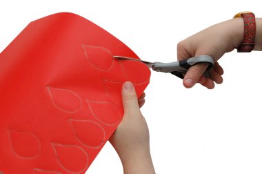 Child hands cutting a paper clipart