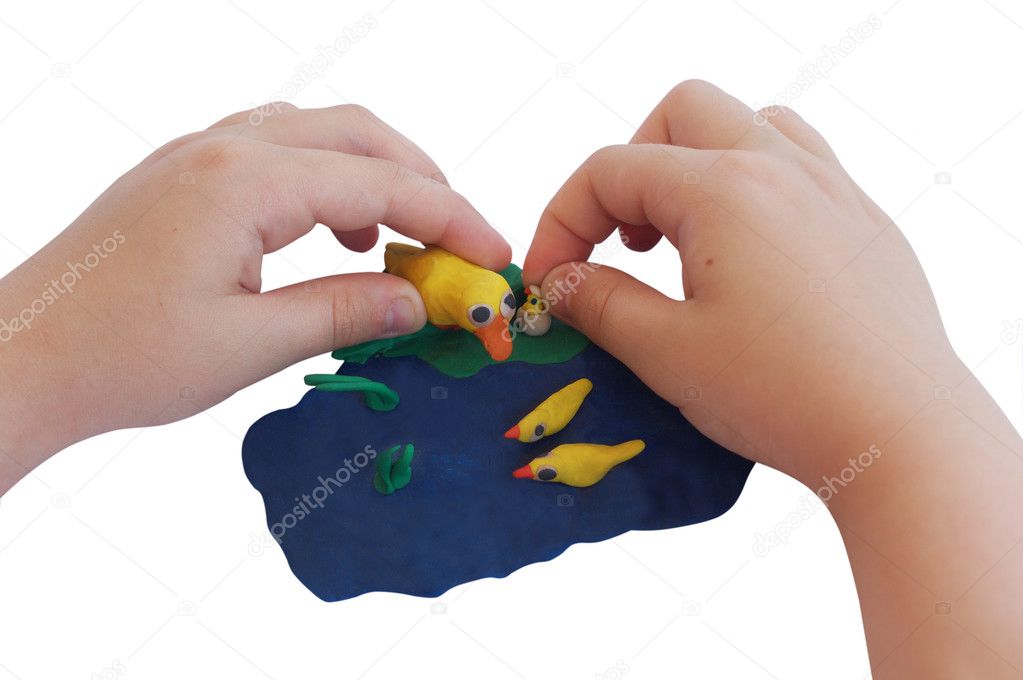Child hands make plasticine composition