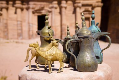 Brass jugs and animal figurines in Petra clipart