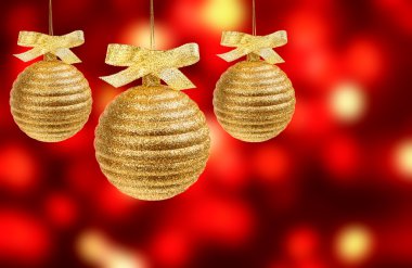 Three golden balls on red background clipart