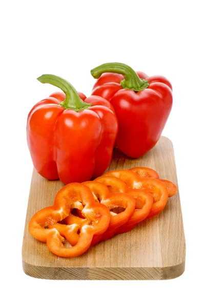 Red paprika and slices on board — Stock Photo, Image