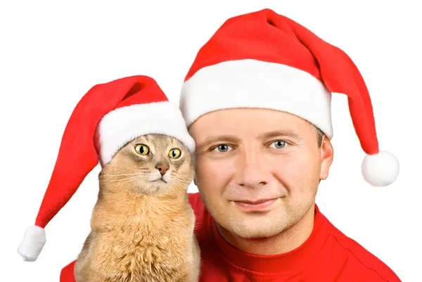 Young man and cat in Santa's hat — Stock Photo, Image