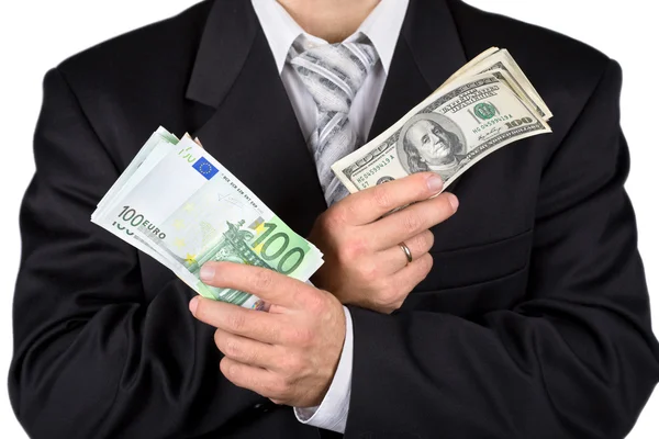 Businessman holding dollars and euros, i — Stock Photo, Image