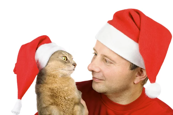 Young man and cat in Santa's hat — Stock Photo, Image