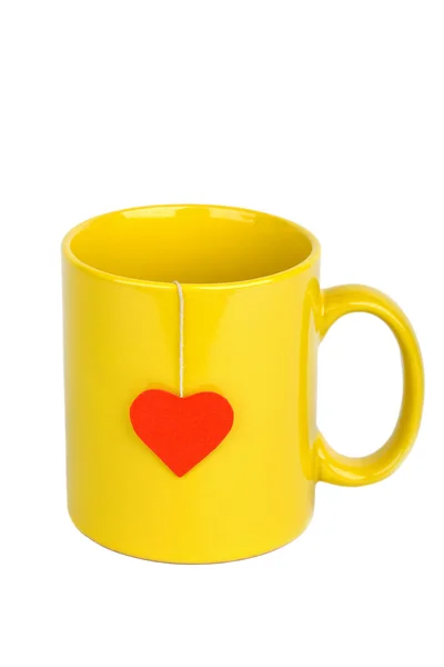 Tea bag with heart-shaped label in cup — Stock Photo, Image