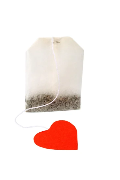 Tea bag with heart-shaped red label — Stock Photo, Image