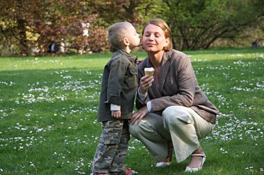 Boy kissing mother clipart