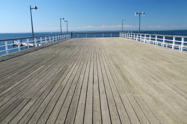 Wooden pier over a sea clipart