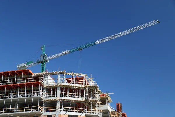 Construction crane against blue sky Stock Image