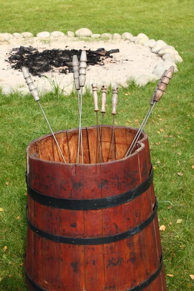 Red barrel with metal skewers — Stock Photo, Image