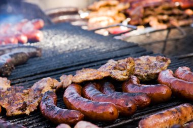 Sausage and meat on barbequeue clipart