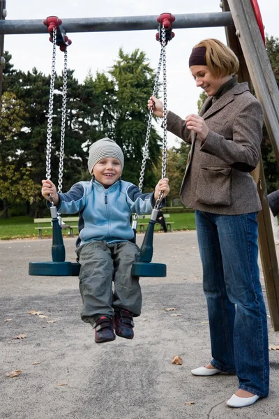 Mother and son on swing — Stock Photo, Image