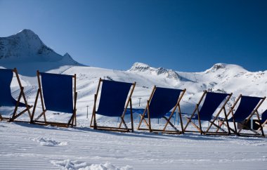 Deckchairs in front of slope clipart