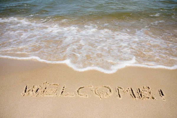 Welcome written in sandy beach — Stock Photo, Image