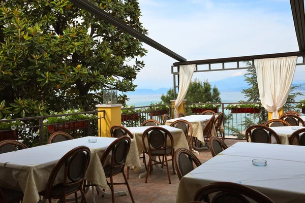 stock image Open porch restaurant against water and