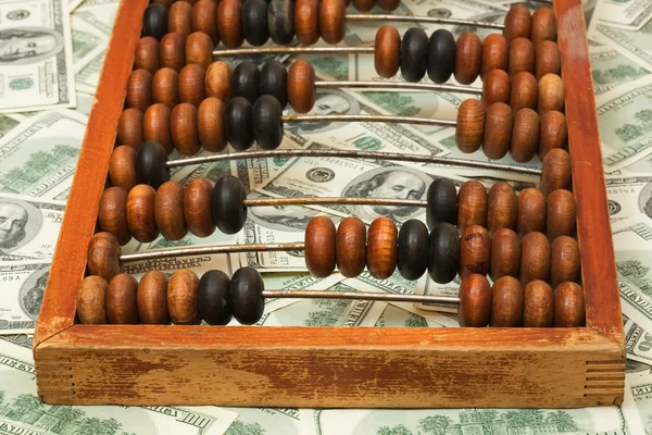 Old abacus on dollars — Stock Photo, Image