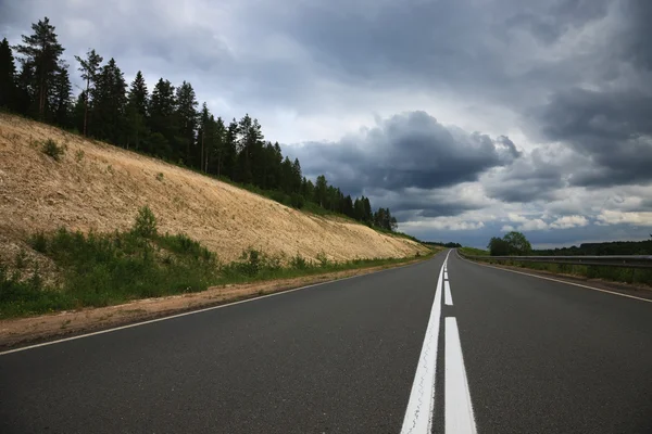 Grey road, grey clouds — Stock Photo, Image