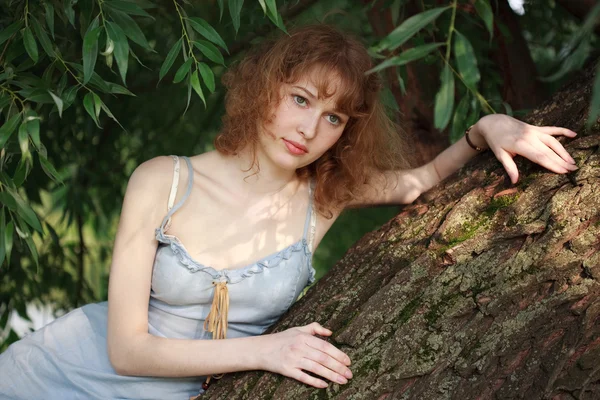 stock image Thoughtful girl on a tree