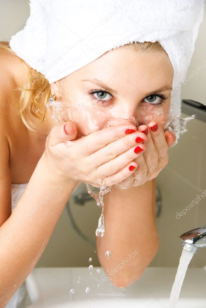 Beautiful girl washing her face