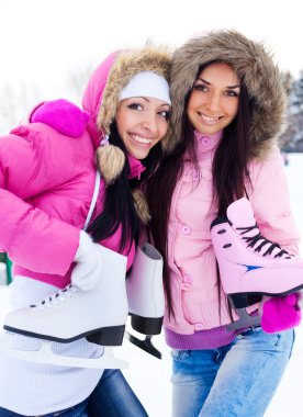 Two girls go ice skating clipart